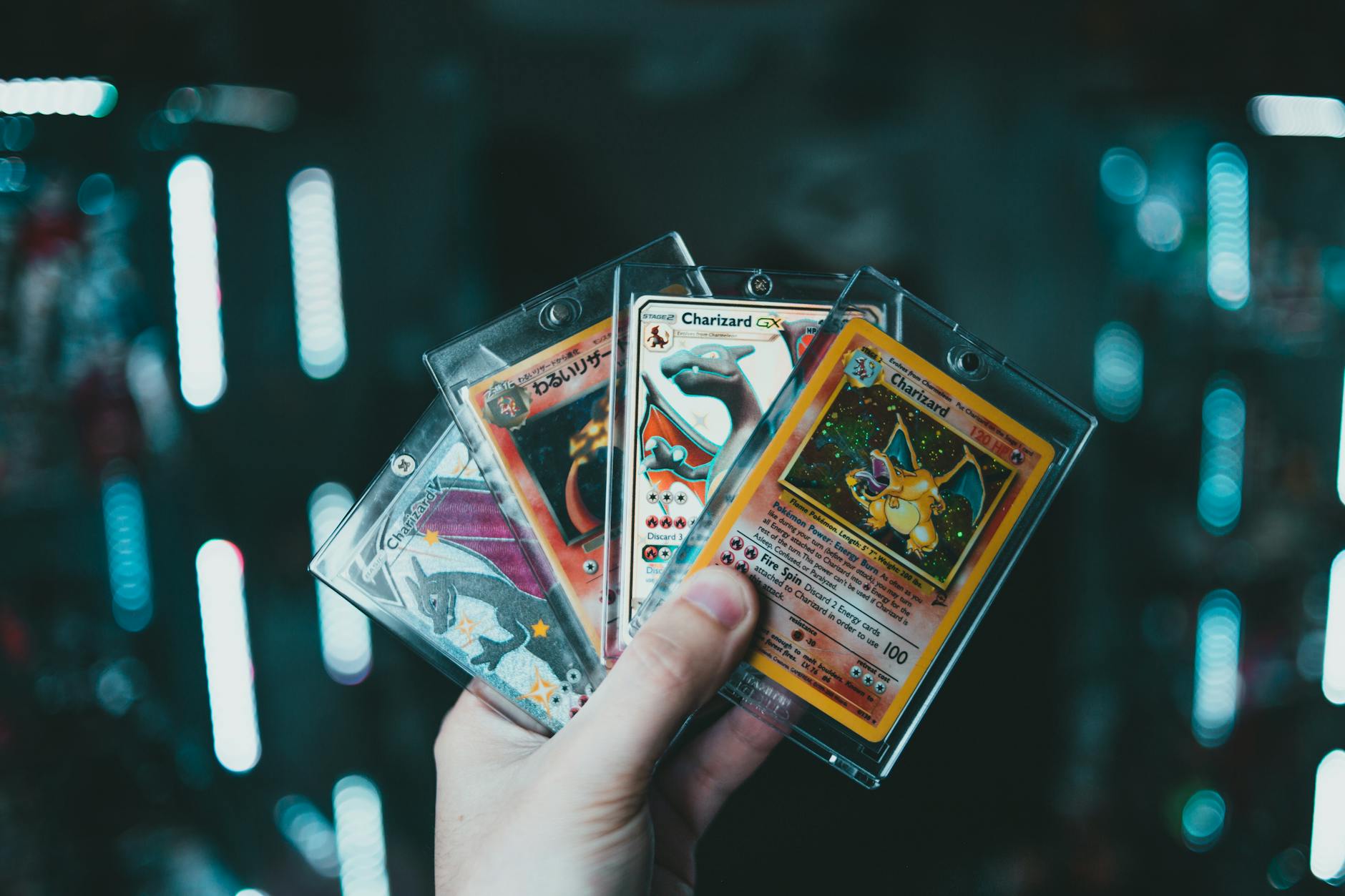High-grade Charizard Pokémon card under glass displayed next to a digital NFT representation, illustrating tokenized Pokémon cards bridging physical collectibles and blockchain technology.